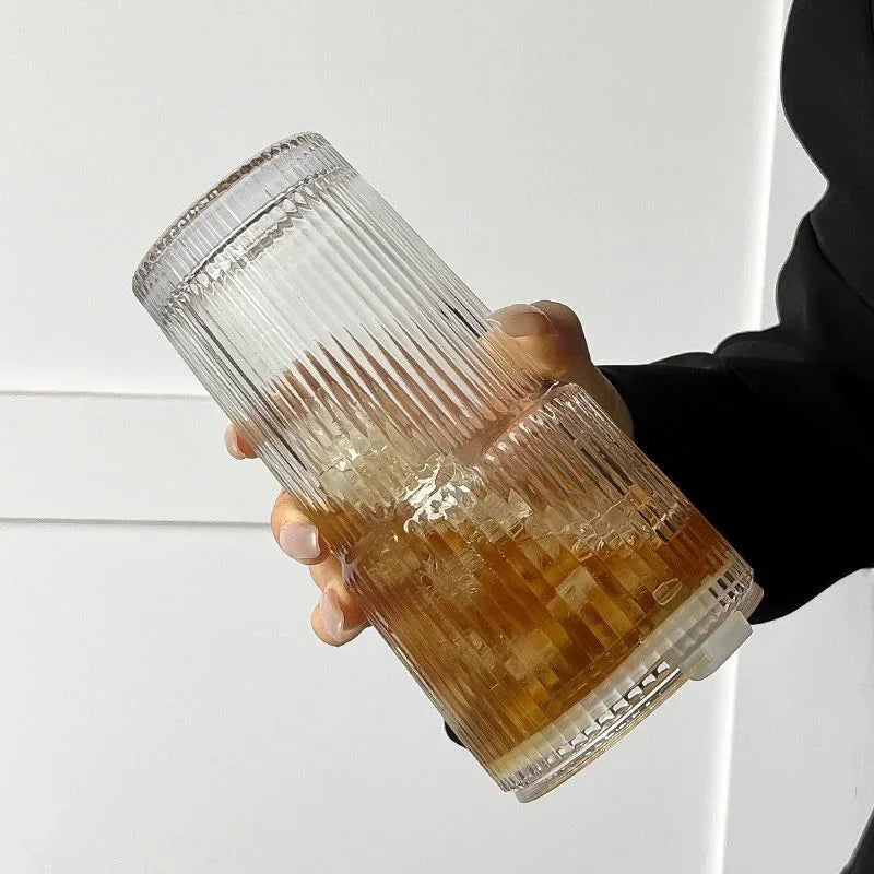 Striped glass coffee cup with straw, top view